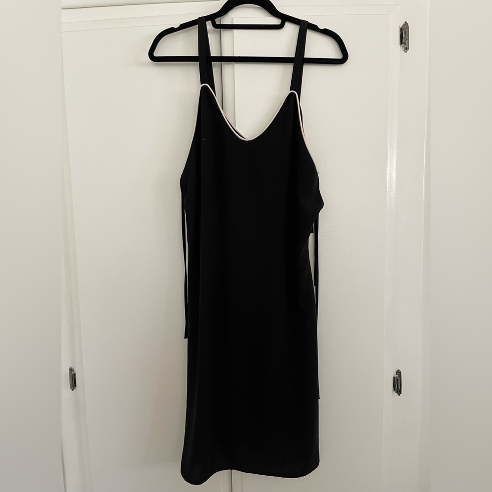 Lumiere black dress with straps and small side cut outs. Size small
